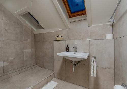 a bathroom with a sink and a shower at Vanilla Suite · Kilchberg in Kilchberg