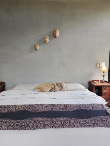 a cat laying on a bed in a bedroom at Los Patios Haras El Malacate in A. de la Cruz