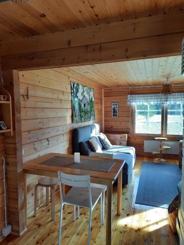 a living room with a couch and a table at Mökki Katjukka, Ruka in Kuusamo