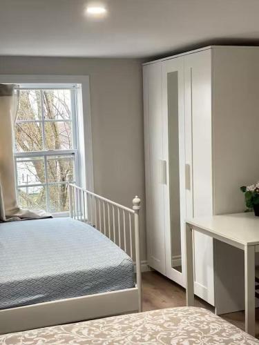 a white bedroom with a bed and a window at Bright Ensuite Room with 2 Queen Beds-3A in Halifax