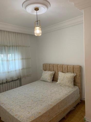 a bedroom with a large bed with two pillows at honey moon zeinbe 4 in Hammamet