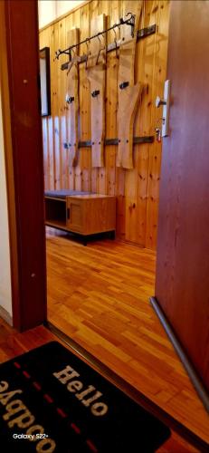 a room with wooden walls and a door with a mat at Ferienwohnung Altes Schulhaus Walberngrün in Grafengehaig