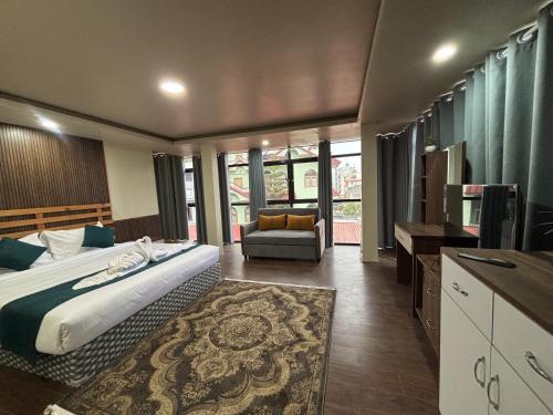 a bedroom with a bed and a couch and a television at Anamnagar Union House in Kathmandu