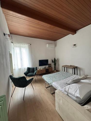 a bedroom with a bed and a desk and a chair at Vintage House in Asciano