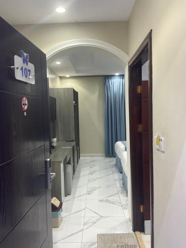 a hallway of a hospital room with a door and a bathroom at فندق اجنحه البيداء فرع2 AlBaydaa Suites Hotel Branch in Medina