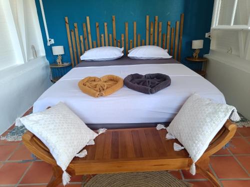 a bedroom with two beds with hearts on the bed at Domaine kaliope in Le Robert