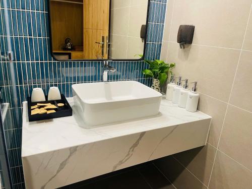 a bathroom with a white sink and a mirror at Sweet Home in Gò Ba Quần
