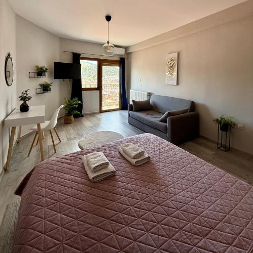 a bedroom with a large bed with two towels on it at Panoramic suite in Kastoria
