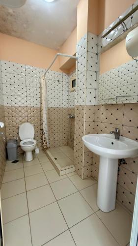 a bathroom with a toilet and a sink at Dhermi Light Rooms in Dhërmi