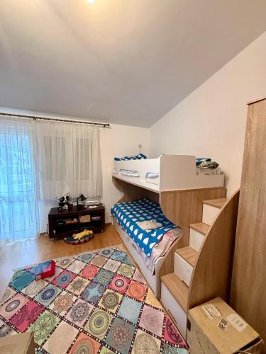 a bedroom with a bunk bed and a rug at King Apartment in Sutomore