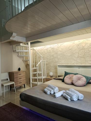 a bedroom with a bed with pillows and a staircase at Casa vacanze So Suite 24 in Reggio di Calabria