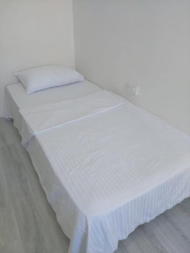 a large white bed in a white room at Alaçatı evi in Alaçatı