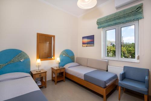 a room with two beds and a window at Socrates Holidays Apt 3 with Pool near the Beach in Kamisianá