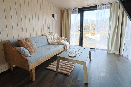 a living room with a couch and a table at WAKE INN by Pidu-LA in Abula