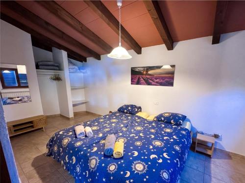 a bedroom with a blue bed with shoes on it at Casa Ana Istria 1 in Savudrija