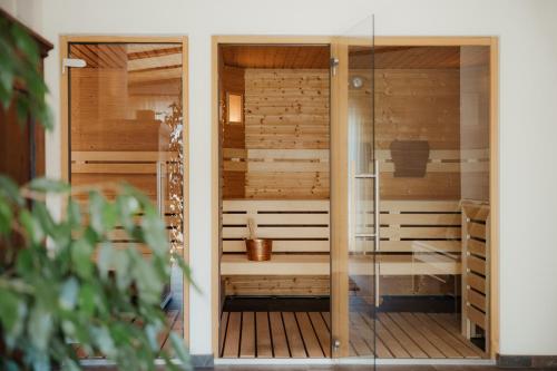 a sauna in a house with a glass door at Albergo Stella in La Villa