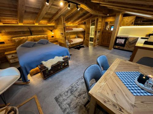 a bedroom with a bed and a table and chairs at Chalet-Kitzalpen in Hollersbach im Pinzgau