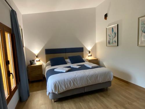 a bedroom with a large bed with two lamps on it at Mirador de Aledo in Aledo