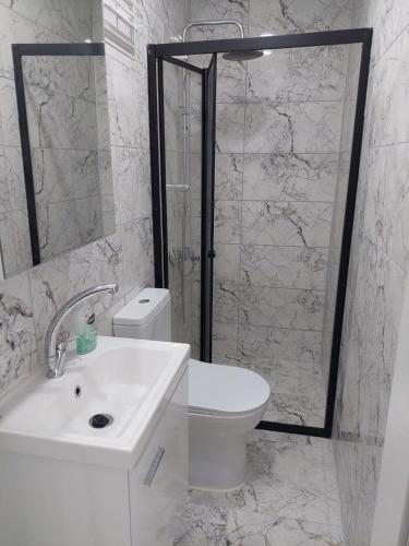 a bathroom with a toilet and a sink and a shower at Alaçatı evi in Alaçatı