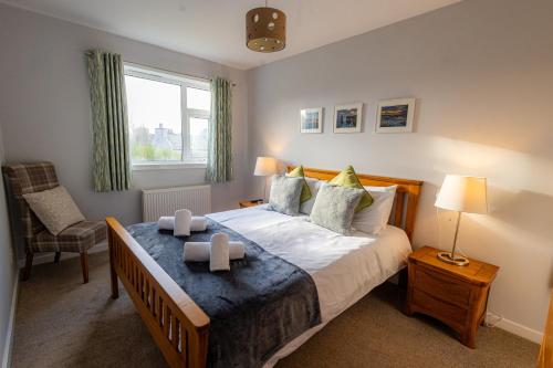 a bedroom with a bed with two candles on it at Havrock in Orkney