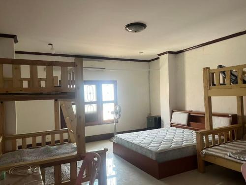 a room with two bunk beds and a window at FUBON World Hostel in Ban That-Louang