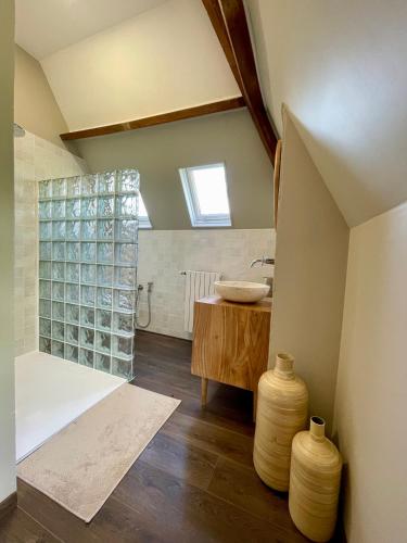 a bathroom with a sink and a shower with a counter at La Maison Maya Normandie in Saint-Éloi-de-Fourques