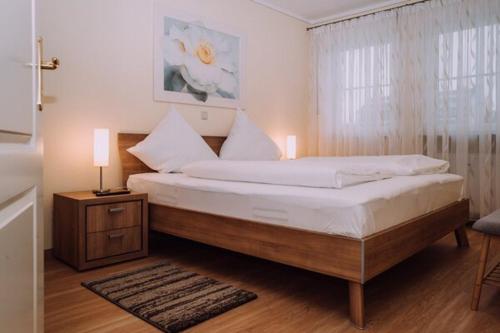 a bedroom with a large bed and a window at Europa Residenz Bad Füssing in Bad Füssing