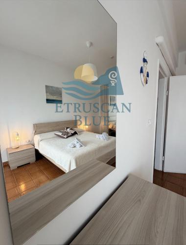 a bedroom with a bed and a sign on the wall at Etruscan Blue House in Piombino