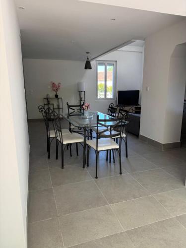 a dining room with a table and chairs at sologne detente in Souesmes