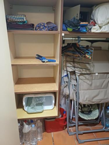 a closet filled with lots of shelves and a drawer at Our dream in blue in Sèze