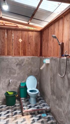a bathroom with a toilet and a shower at Frits Homestay in Kri