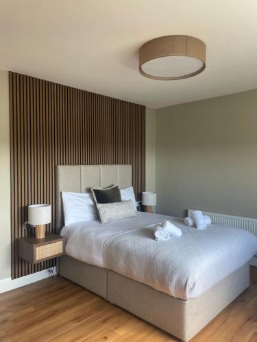 a bedroom with a large bed with two lamps on it at Glasha Meadows Accommodation in Doolin