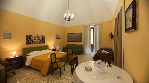a bedroom with a bed and a table in a room at B&B Giardino Incantato in Piazza Armerina