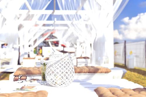 a white table with donuts and a vase on it at Termy Warmińskie in Lidzbark Warmiński