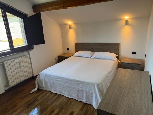 a bedroom with a large bed and a wooden floor at Casa Alma in Cogliate