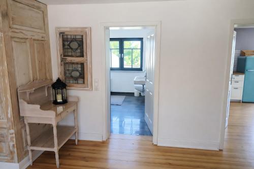 a kitchen with white walls and a wooden floor at Ferienhaus in Graal-Müritz in Graal-Müritz