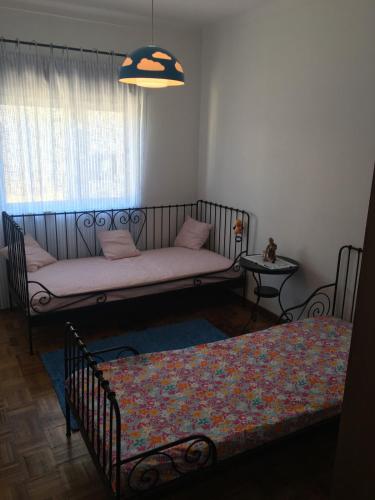 a living room with a couch and a window at Lovely grandma house in Vila Viçosa