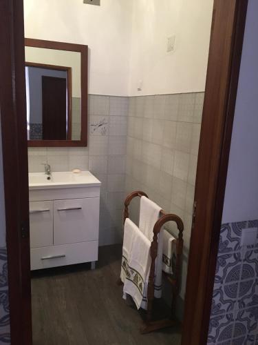 a bathroom with a sink and a mirror at Lovely grandma house in Vila Viçosa