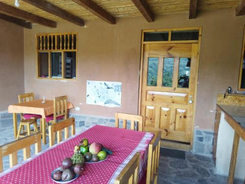 a kitchen with a table with a bowl of fruit on it at GAIA kuelap in Nuevo Tingo