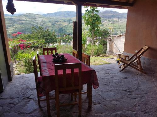 a dining room table with a view of the mountains at GAIA kuelap in Nuevo Tingo