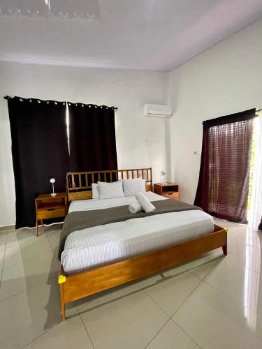 a bedroom with a large bed in a room at Arenal Views, Pool & 5min to Waterfall & Town in Fortuna