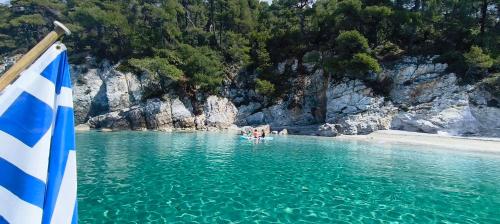 a group of people in the water near a beach at ARGO III Sailing Yacht in Skiathos