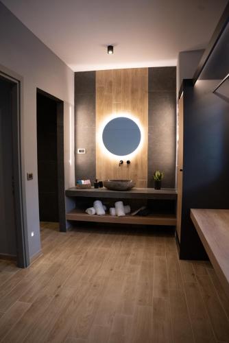 a bathroom with a sink and a mirror at Τzegia Suites in Galissas