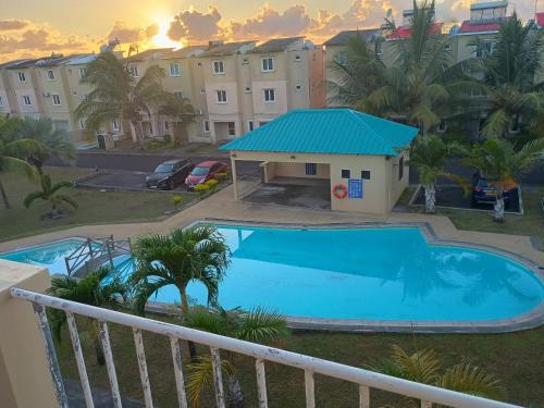 a view of the pool from the balcony of a apartment at Triplex - Suite parentale in Grande Gaube