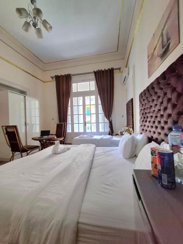 a large white bed in a room with a large window at Dawn town palace in Cairo