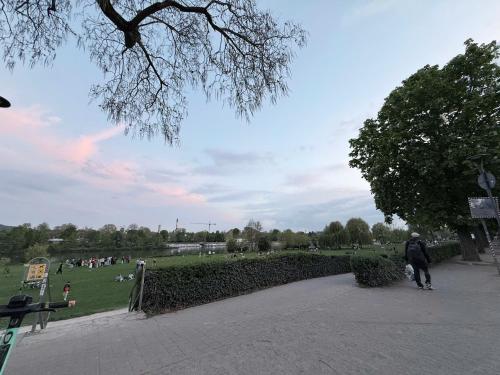 a person walking down a path in a park at Nora Private Home on Neckar in Heidelberg