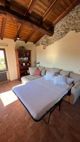 a large bed in a living room with a couch at Ancient townhouse next castle in Vezzano Ligure