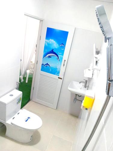a bathroom with a toilet and a sink and a window at Oasis2 Phuket Airport Glamping in Phuket