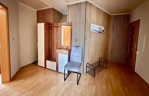 a empty room with a chair and a window at Ferienwohnung Hochwaldblick 2 in Morbach