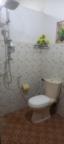 a bathroom with a toilet and a shower at Reegina Villa in Chunnakam